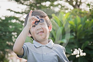 Chld playing fidget spinner on nature background