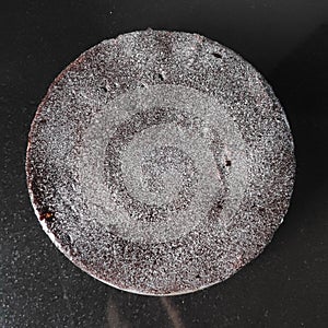 Choclate cake topped with powdered sugar. photo