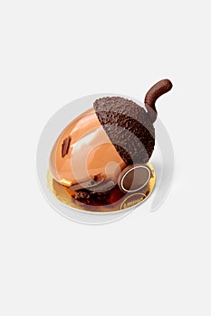 Chocolate acorn shaped cake in glossy ganache on white