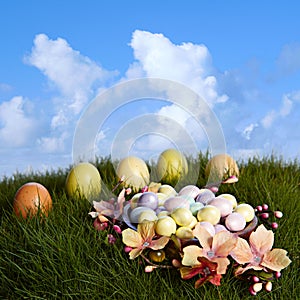 Chocolate Almond Candy Easter Eggs In Yellow, Pink, Purple &Blue Sitting On Natural Growing Grass With Green & Brown Easter Eggs