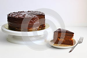 Chocolate Austrian dessert Sacher with apricot jam. chocolate dessert on light colored background. sliced cake concept