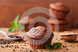 Chocolate banana muffin on wooden vintage background. Delicious homemade bakery.