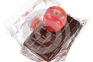 Chocolate bar black cacao vs red apple in diet concept