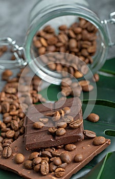 Chocolate bar with a glass jar of coffee beans