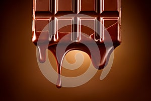 Chocolate bar with melted dark chocolate dripping over dark brown background. Confectionery concept backdrop. Melted chocolate