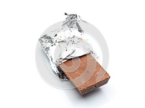 Chocolate bar with open aluminium wrapper