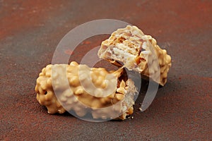 Chocolate bar with peanut butter and caramel on dark background