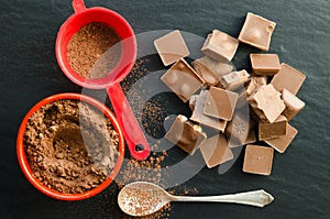 Chocolate bars with heap of cacao powder