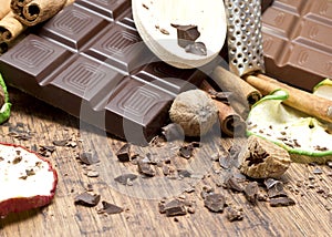 Chocolate bars stack, apples and cinnamon sticks