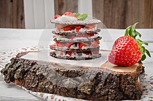 Chocolate belgian waffles with strawberries, whipped cream and m