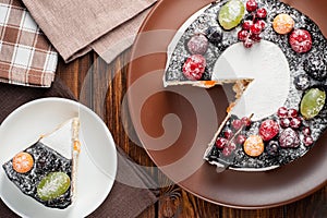 chocolate berry cake on plate over brown wooden background
