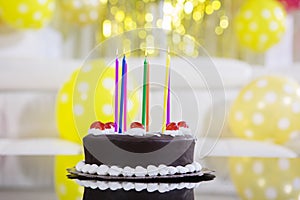 Chocolate birthday cake with colorful candles