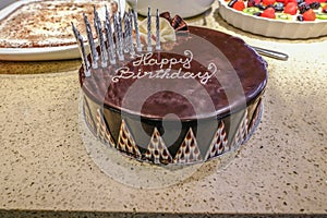 Chocolate Birthday cake decorated and dressed with candles