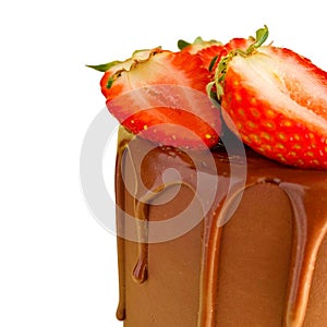 Chocolate birthday cake decorated with fresh organic strawberries isolated on a white background.