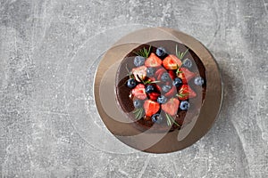 Chocolate birthday cake with strawberry and blueberry. Top view