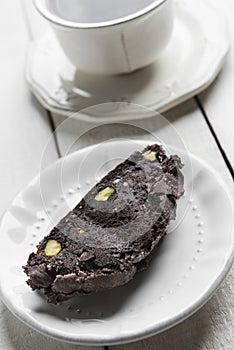 Chocolate biscotti with a cup of coffee in the background.