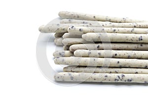 Chocolate biscuit stick coated with milk flavour confectionery and crushed cookies and cream taste isolated on white background