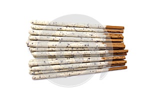 Chocolate biscuit stick coated with milk flavour confectionery and crushed cookies and cream taste  on white background