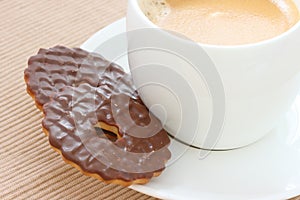 Chocolate biscuits on saucer with coffee