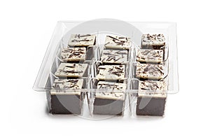 Chocolate brownie bites with sparklng chocolate topping isolated on white