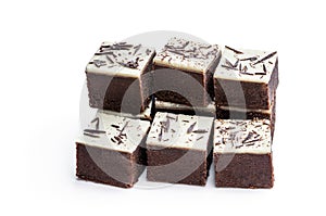 Chocolate brownie bites with sparklng chocolate topping isolated on white