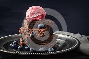 Chocolate brownie with blueberry and ice cream on the vintage plate horizontal