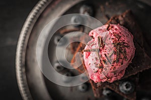 Chocolate brownie with blueberry and ice cream on the vintage plate top view