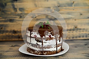 Chocolate brownie cake with cherries on a wooden table