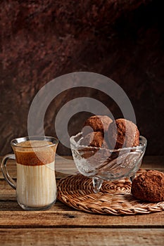 chocolate brownie potatoes in a crystal vase and dalgon coffee on a textured beautiful background.