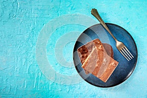 Chocolate brownie, simple coffee cake, overhead flat lay shot on blue