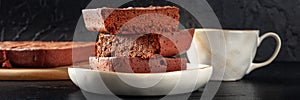 Chocolate brownie with tea panorama, simple coffee cake, a side view