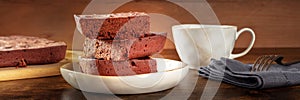 Chocolate brownie with tea, simple coffee cake, a side view panorama