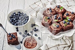 Chocolate brownies with berries on a stand