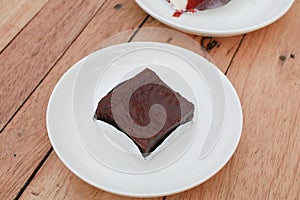 Chocolate brownies cake on white plate wooden table. homemade bakery and dessert.