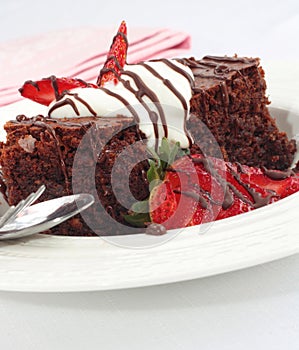 Chocolate brownies with strawberries and cream