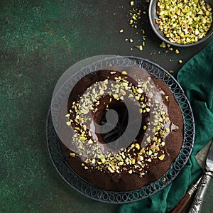 Chocolate bundt cake with chocolate glaze and pistachios