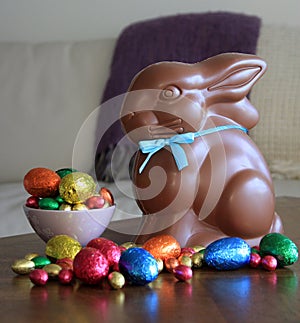 Chocolate bunny with Easter eggs on table