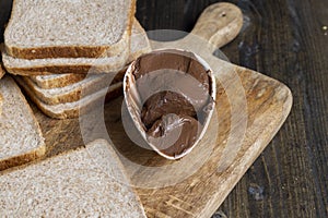 Chocolate butter spread on bread while cooking breakfast