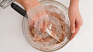 Chocolate buttercream frosting recipe. Woman mixing ingredients