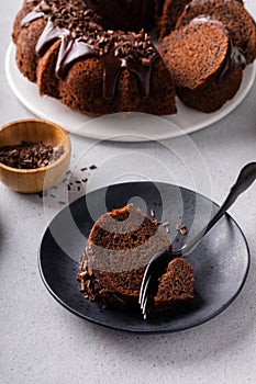 Chocolate cake baked in a bundt pan with chocolate ganache glaze