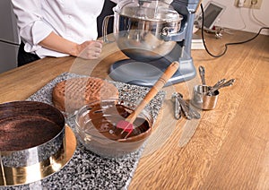 Chocolate cake baking ingredients on kitchen table with kitchenware, top view