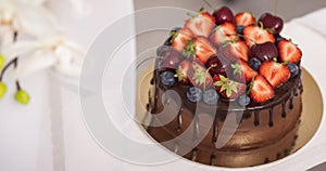 Chocolate cake with berries with beauty background.