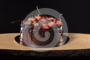 Chocolate cake with berries with beauty background.