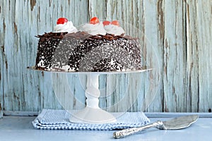 Chocolate cake with cherries and whipped cream