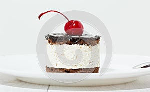 Chocolate cake with cherry on the top icing
