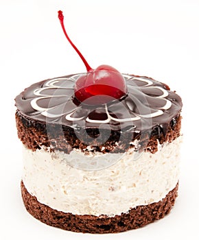 Chocolate cake with cherry on the top icing isolated on a white