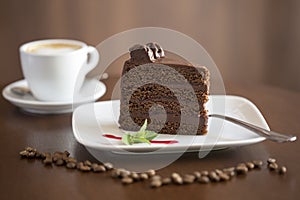 Chocolate Cake with coffee cup in the background - slice photo