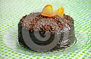 Chocolate cake covered with ganache and orange peel