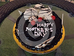 Chocolate cake with cream and nuts on special occasion of Mother's Day