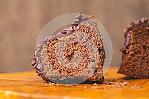 Chocolate cake with creamy chocolate sauce and decorated with chocolate sprinkles.